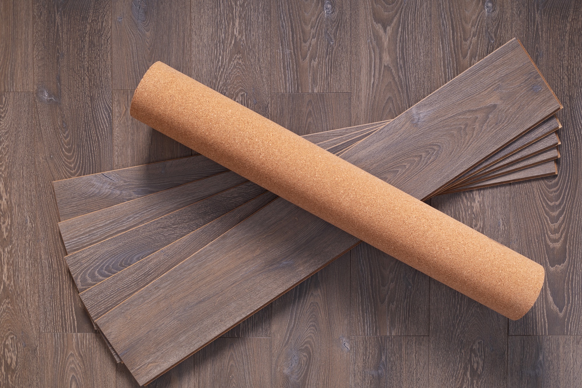 Cork roll and laminate floor wood background texture. Wooden laminate floor plank